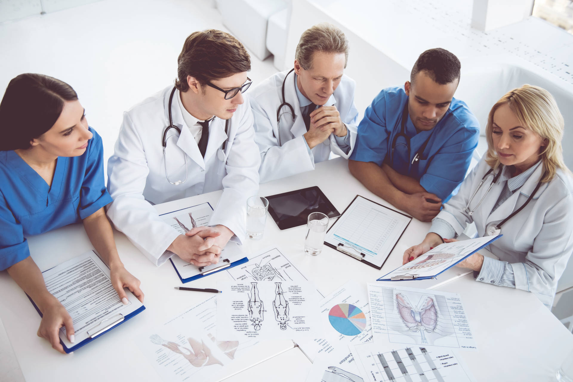 Medical team reviewing charts around table